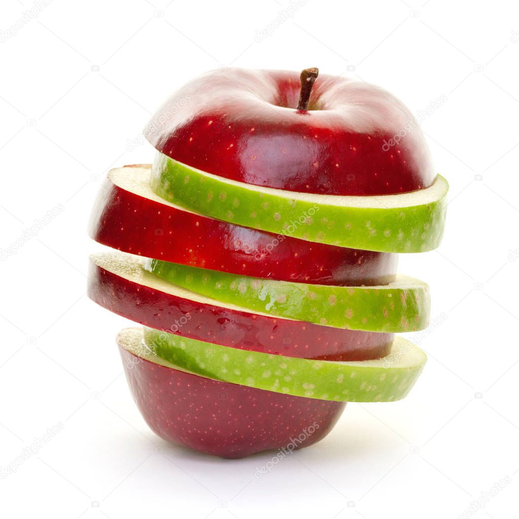 Mixed green and red apple slices piled up and isolated on white background.