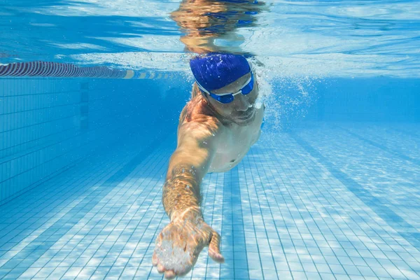 Young man swimming in pool