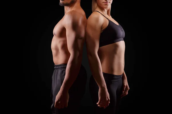 Sporty couple on dark background