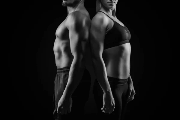 Sporty couple on dark background