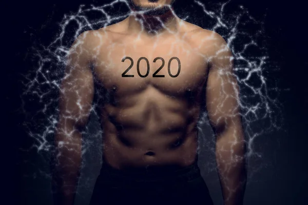 Perfectly shaped male upper body with 2020 tattoo Stock Photo