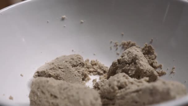 A man breaks halva with a spoon into small pieces — Stock Video