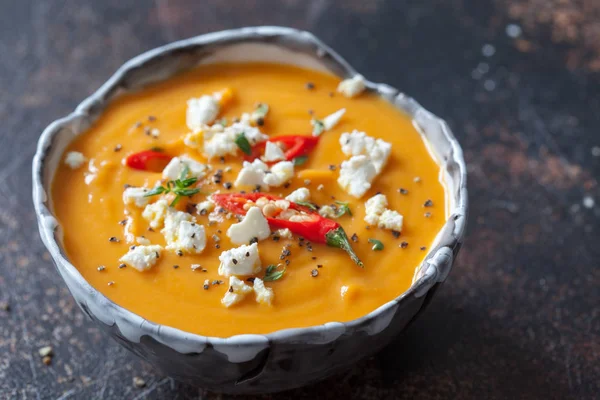 Roasted pumpkin and carrot soup with feta cheese and chili — Stock Photo, Image