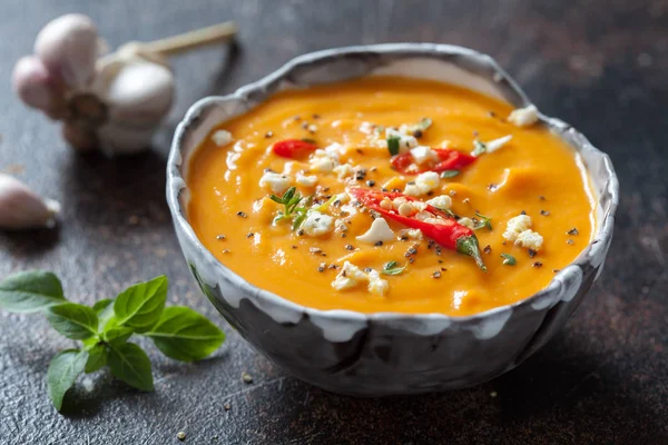 Roasted pumpkin and carrot soup with feta cheese and chili — Stock Image Roasted pumpkin and carrot soup with feta cheese and chili Royalty Free Stock Photos