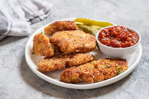 Fried crispy chicken nuggets with ketchup and pickles — Stock Photo, Image