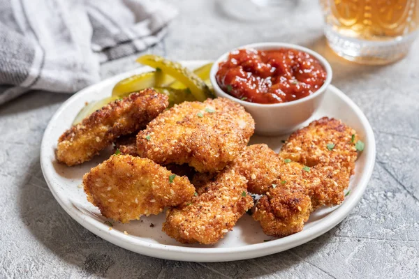 Fried crispy chicken nuggets with ketchup and pickles — Stock Photo, Image