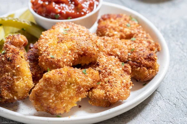 Fried crispy chicken nuggets with ketchup and pickles — Stock Photo, Image