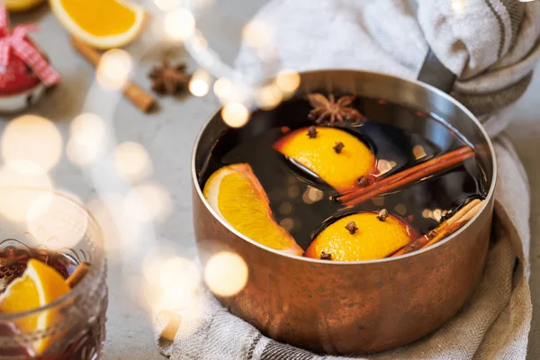 Mulled wine hot drink with oranges and spices in copper pot — Stock Photo, Image