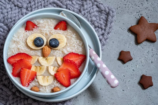 Kids breakfast oatmeal porridge with berries and nuts — Stock Photo, Image