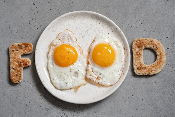 Word food written with toast letters eggs