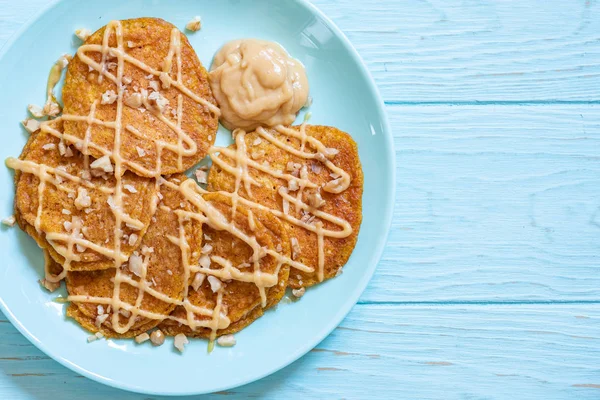 Pumpkin pancakes with pear sauce and a walnut — Stock Photo, Image