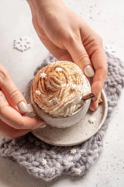 Hot chocolate with cream and cinnamon stick in a ceramic cup — Stock Photo, Image