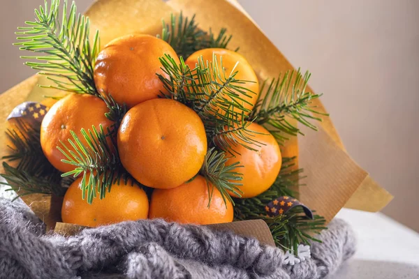 Handmade fruit bouquet of mandarin and Christmas tree branches