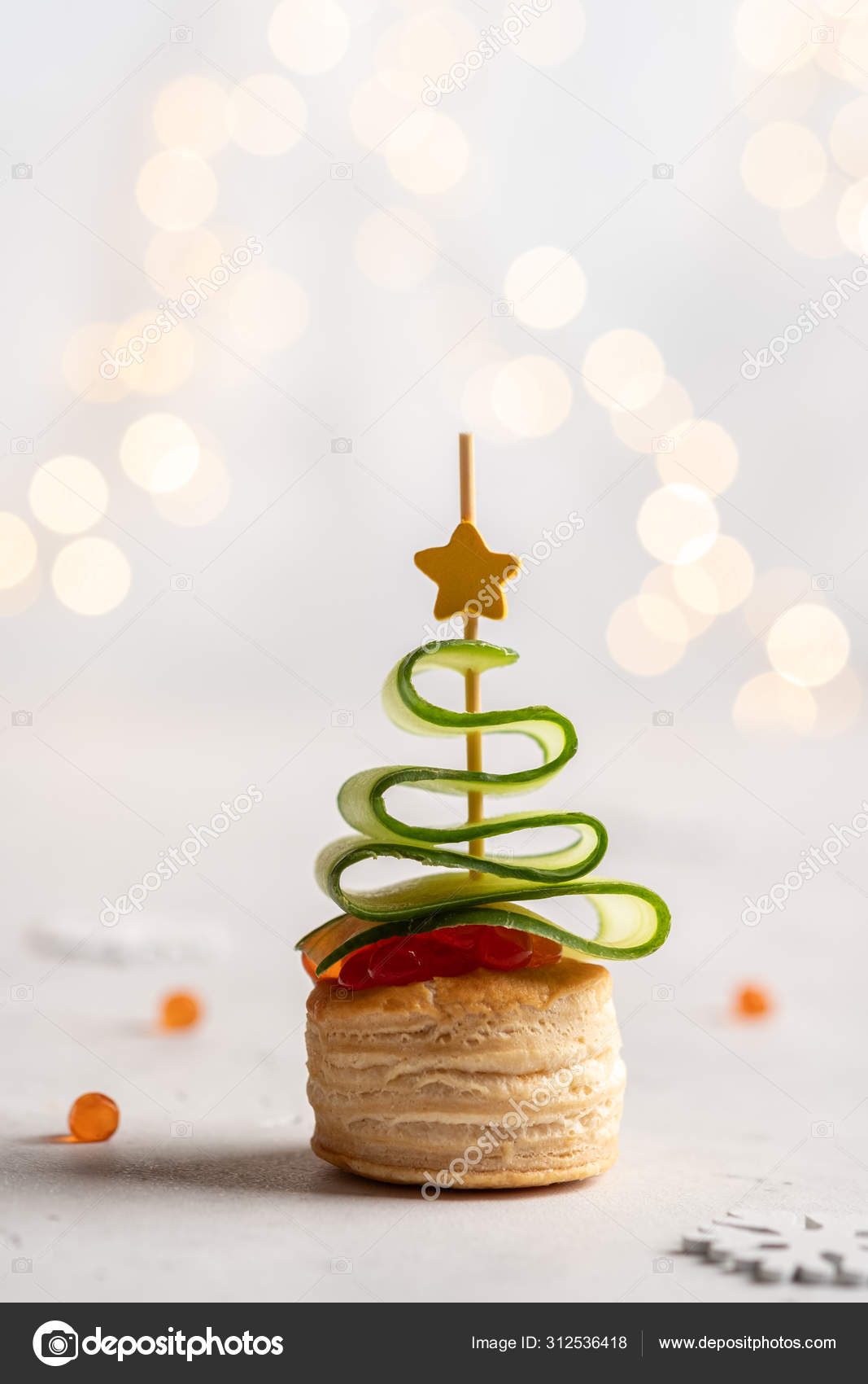 Christmas tree canape with cucumber slice, salmon pate and red