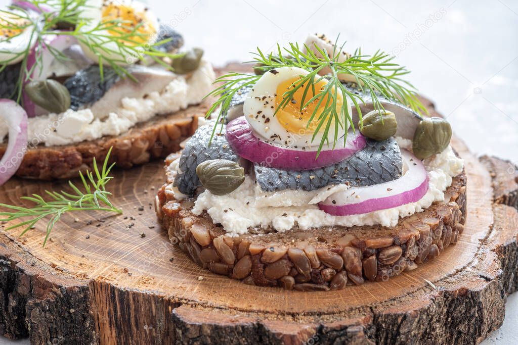 Smorrebrod with herring, onion and eggs