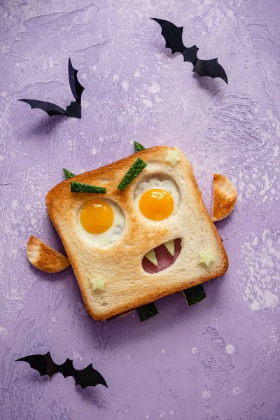 Leuke Halloween monster sandwich met plak vlees worst, eieren en kaas op bord — Stockfoto