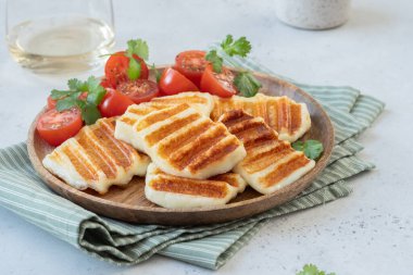 Grilled Halloumi Cheese and tomato salad. clipart