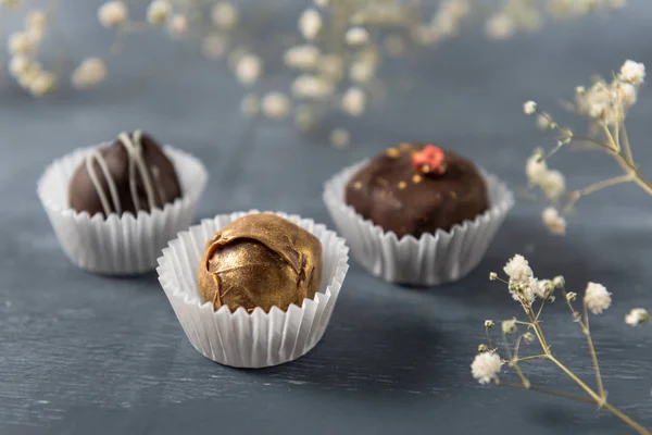 Handmade chocolate candies, white, dark and milk chocolate in box. Sweets background