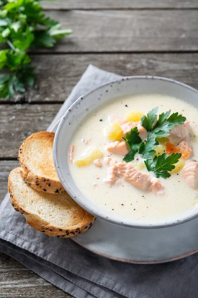 Finnish creamy soup with wild salmon, potatoes, carrots and parsley. Healthy food. Dieting. Finnish cuisine. Close up — Stock Image Finnish creamy soup with wild salmon, potatoes, carrots and parsley. Healthy food. Dieting. Finnish cuisine. Close up Royalty Free Stock Photos