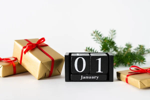 1 January calendar with presents and fir branches on white background, preparation for holiday, Happy New Year and Xmas, new start Concept. Copy space for text, horizontal.