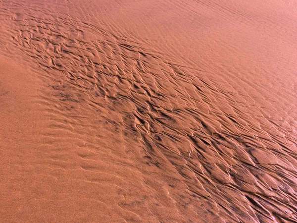 patterns created n the sand by waves and wind, sand pattern as background