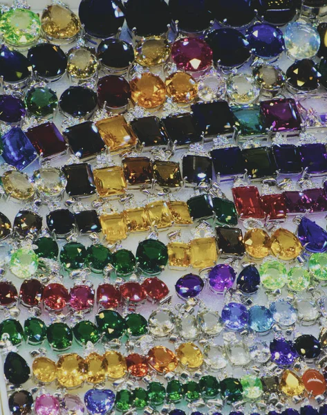 Bright Cheap Women Bijouterie Jewelry Shiny Glass Background — Stock Photo, Image