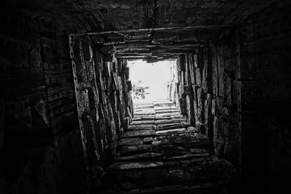 stock image Deep well, the walls of which are lined with stone. Bottom view. Light at the end of the tunnel. Light at the end of the road. Background.