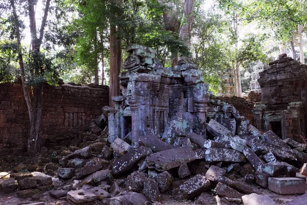 The stone blocks of the collapsed ancient building. Abandoned Khmer buildings in the forest. The ruins of ancient civilizations.