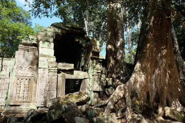 An ancient stone building with a collapsed wall. Dilapidated building of the Khmer Empire. The ruins of an ancient civilization in the forest.