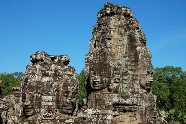 A huge human face built of stone blocks. Huge human faces on the towers of the Bayon temple in Cambodia. Architectural art of ancient civilizations.