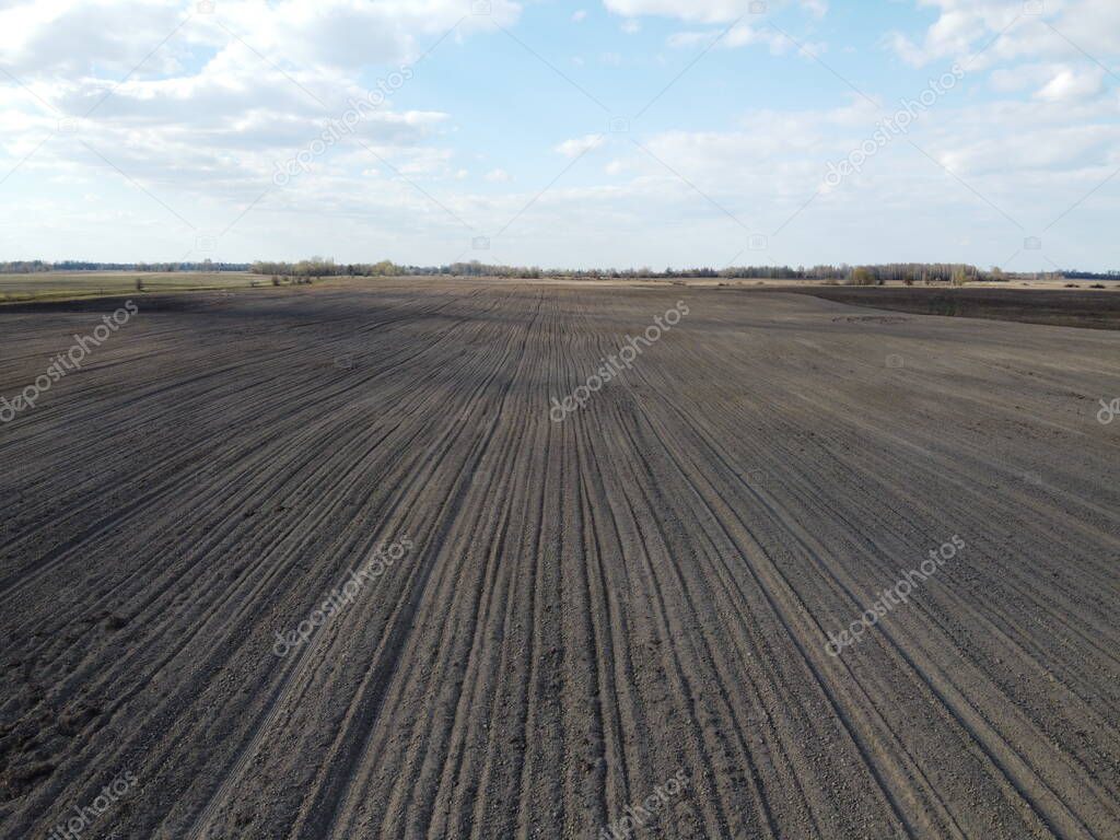 Treated farm field, aerial view. Agricultural land.