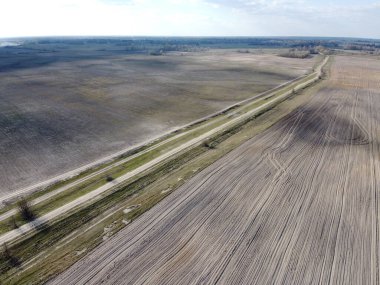 İki tarlanın arasındaki toprak yol, hava manzaralı. Tarım arazisi.