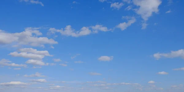 Blue spring sky with white clouds. Beautiful background.