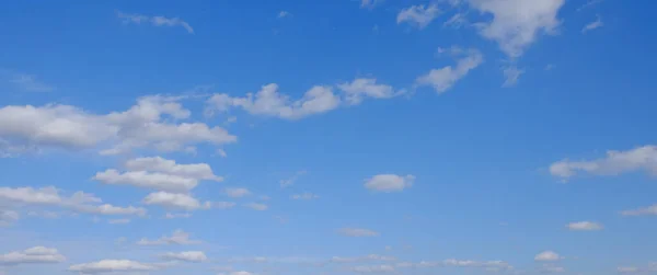 Blue spring sky with white clouds. Beautiful background.