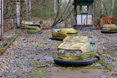 Pripyat 'ta terk edilmiş bir lunaparkta arabalar. Paslı terk edilmiş eğlenceler.