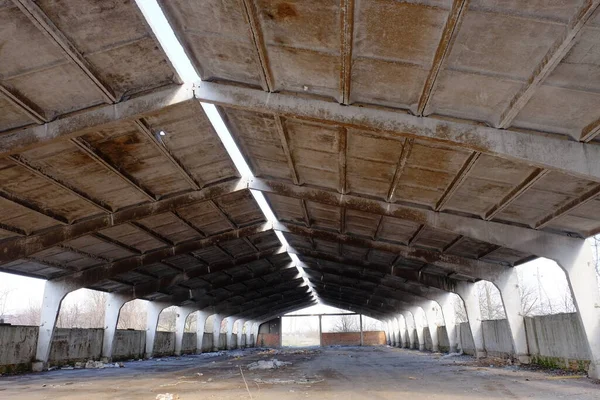 A dilapidated concrete industrial structure. Storage with concrete roof.