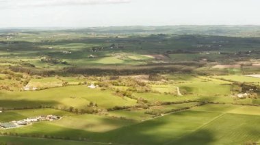 From above, you can see the beautiful green countryside. Ireland's fields and forests are full of sunlight, making them calm and relaxing.