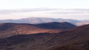 Panoramic exposure of Priest's Leap's impressive mountainous landscape in County Cork, Ireland. Witness the undulating terrain and scenic views of the countryside.