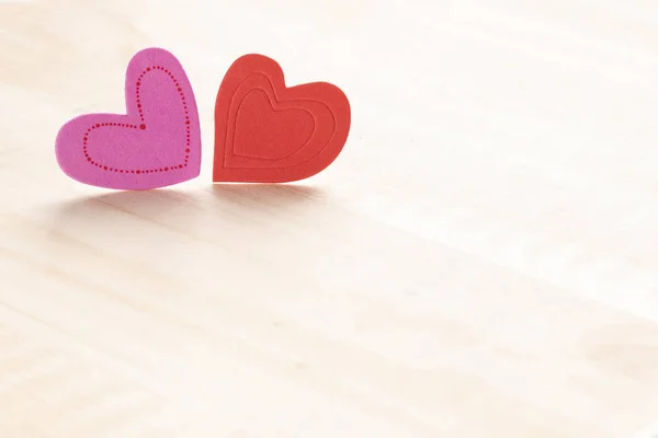 Valentine background with two hearts decoration on a wooden table. Happy Valentines Day card layout, copy space.