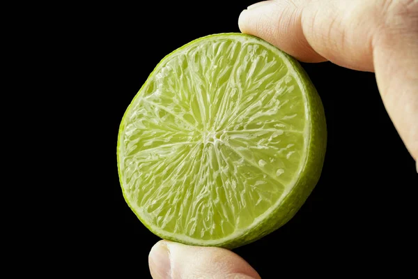 Half lime in the hand of a man. — Stock Photo, Image