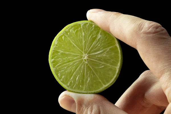 Half lime in the hand of a man. — Stock Photo, Image