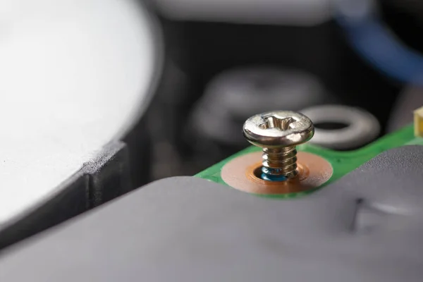 Un tornillo de metal brillante que asegura la placa del procesador, desenroscada por la mitad . — Foto de Stock