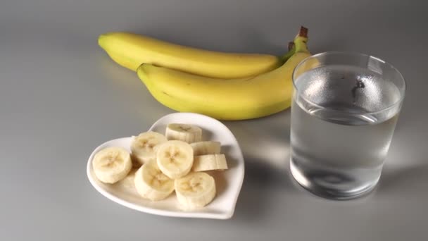 Tranchés Bananes Entières Sur Une Assiette Blanche Sur Fond Gris — Video