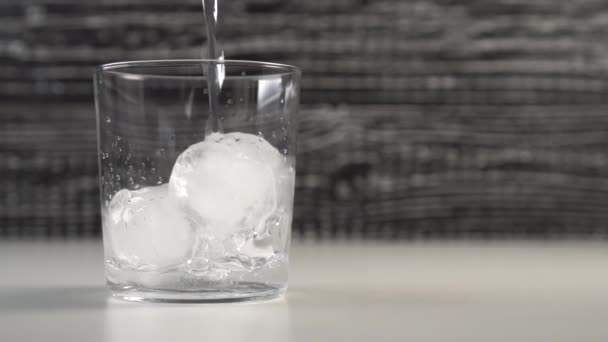 Clear Water Fills Glass Cup Ice Cubes Slow Motion Black — Stock Video