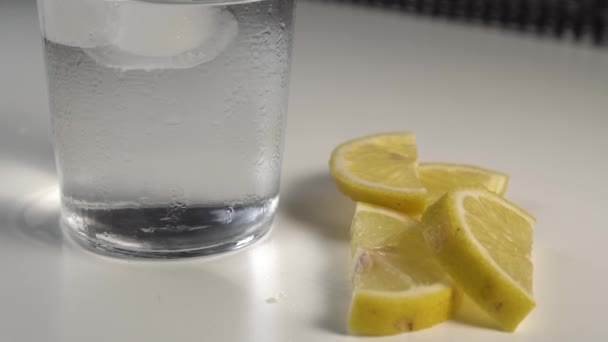 Ice Cubes Move Water Misted Glass White Background Table Slices — Stock Video