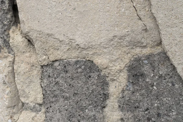 Old ruined gray wall of bricks and cement plaster — Stock Photo, Image