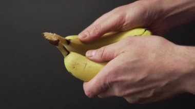 Yakın plan çekimde iki tane olgun muzu kıran eller. Meyve suyu. Boşanma kavramı