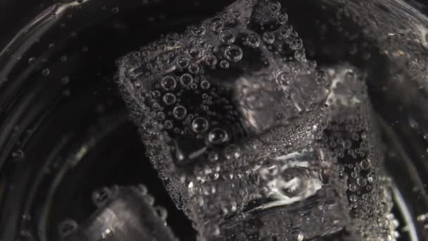 Ice Cubes Bubbles Clear Mineral Water Rotate Glass Close Carbonate — Stock Video