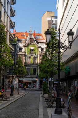 Oviedo, İspanya - 22.07.2020: Avrupa sokaklarında eski ve güzel bir bina. Tıbbi koruyucu maskeli vatandaşlar. Avrupa 'da Coronavirüs