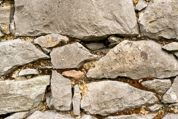 Background of stone wall close up. Piled up chaotically